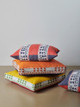Pile of cushions in bright soprano colours with Wayfarer as a trim. Photography by Christopher Horwood